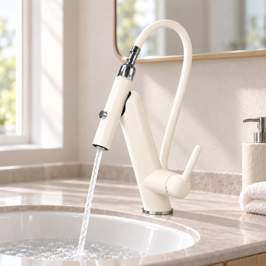 Cream-white faucet running into a white ceramic bathroom washbasin