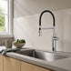 FILER L3 brass kitchen faucet installed behind a kitchen sink