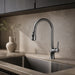Gunmetal pull-down kitchen faucet installed in a warm stone kitchen