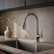 Gunmetal pull-down kitchen faucet installed in a warm stone kitchen