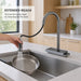 FILER pull-out kitchen faucet rinsing a pan with the extended spray head