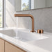 FILER brushed rose gold brass two-hole basin faucet — installed running-water bathroom scene