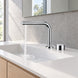 FILER chrome brass two-hole basin faucet — installed running-water bathroom scene