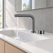 FILER gunmetal brass two-hole basin faucet — installed running-water bathroom scene