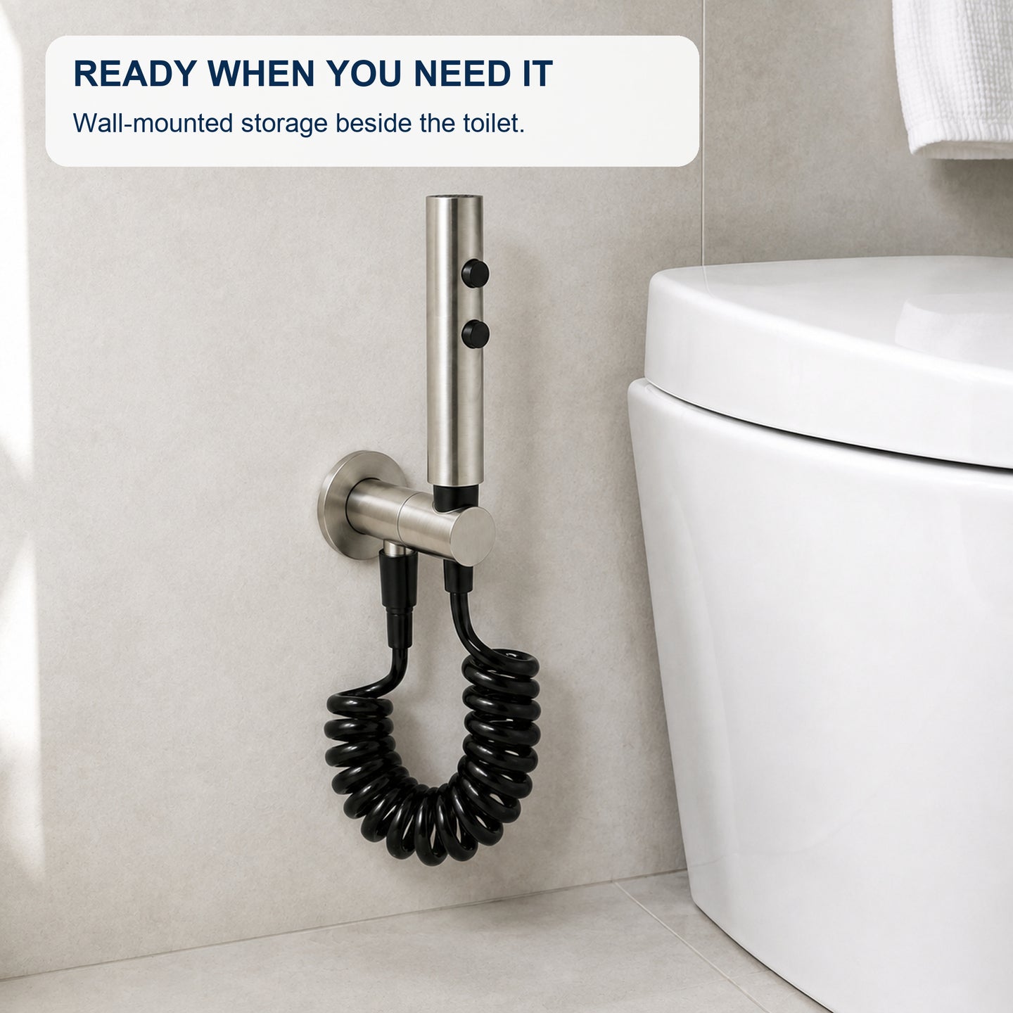 FILER push-button stainless steel bidet sprayer with black coiled hose — installed bathroom scene