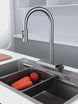 Rain-curtain and pull-out kitchen faucet demonstration; sink shown for context