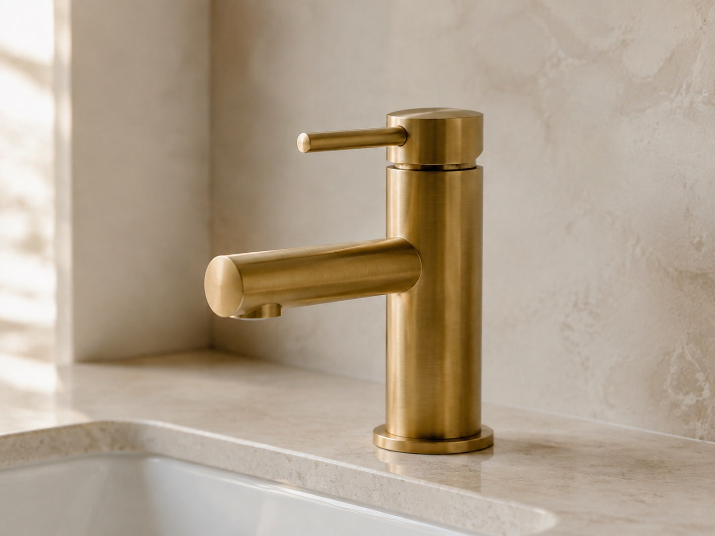 Brushed brass basin faucet with a warm metallic finish